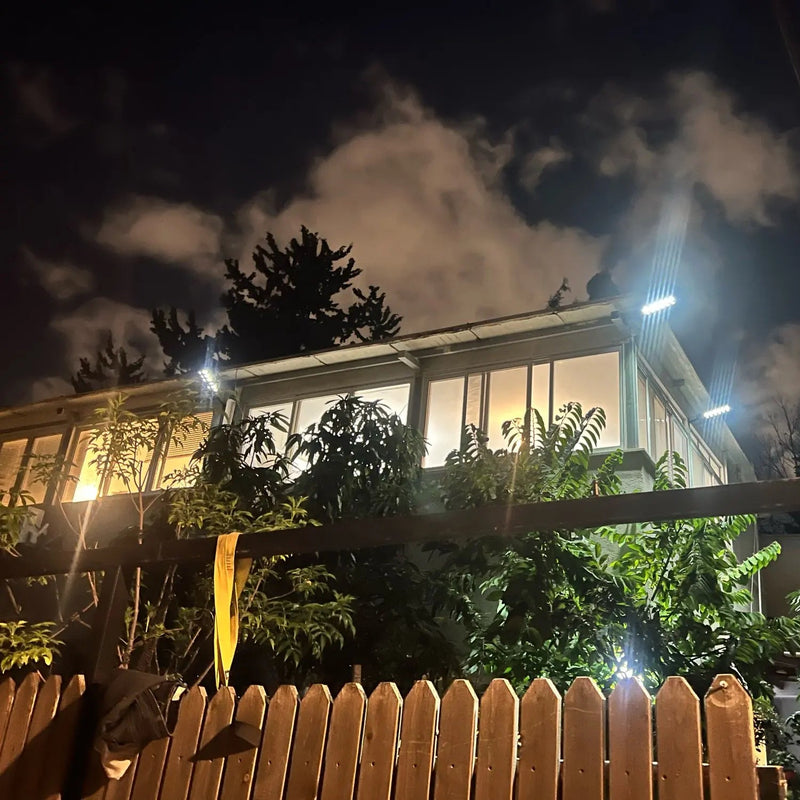 6000-lumen solar outdoor light demonstrating broad nighttime coverage across a large yard, driveway or open garden area