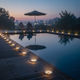 Solar disk pathway lights positioned along a poolside landscape edge at night