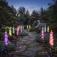 Solar delphinium flower lights adding gentle decorative illumination to a memorial garden at night