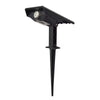 Black high-power solar tree light with integrated solar panel, adjustable spotlight head and long ground stake on a white background