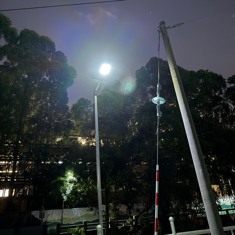 Commercial solar flood light system components showing the LED lamp, solar charging panels and mounting hardware