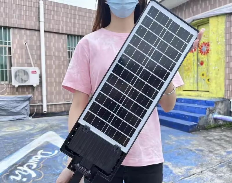 High-output commercial solar light illuminating a large outdoor property area at night from an elevated wall position