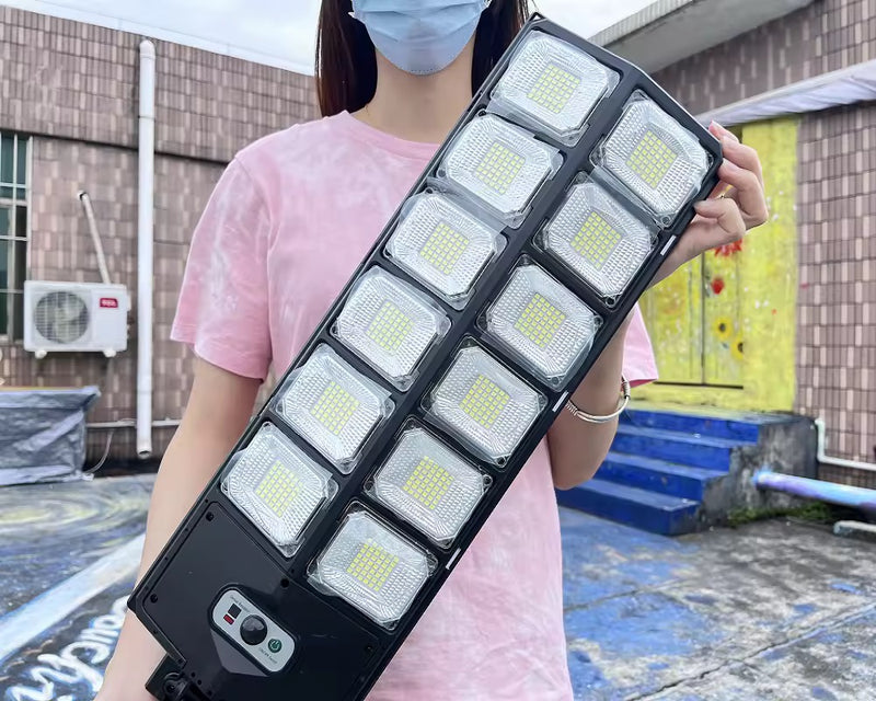 Commercial solar light mounted high on an exterior wall for broad illumination across a residential or commercial outdoor area