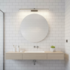 LED wall light in subway tile bathroom