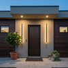 Modern American suburban house front porch with LED wall lights on both sides at dusk