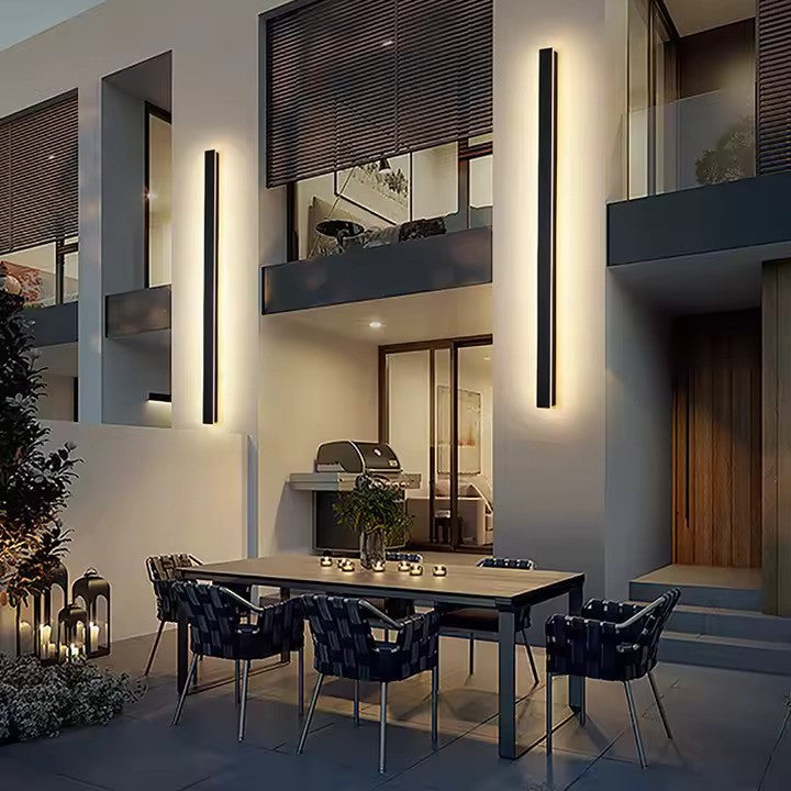 Modern black outdoor LED wall sconce with a slim vertical profile for patios, entrances and architectural facades
