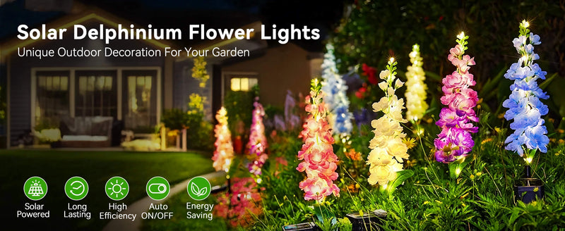 Solar delphinium flower lights arranged across a lawn and planting area as decorative outdoor lighting at dusk