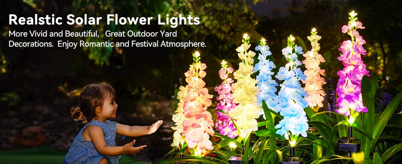 Solar delphinium flower lights glowing beside a garden pathway to create decorative nighttime floral illumination