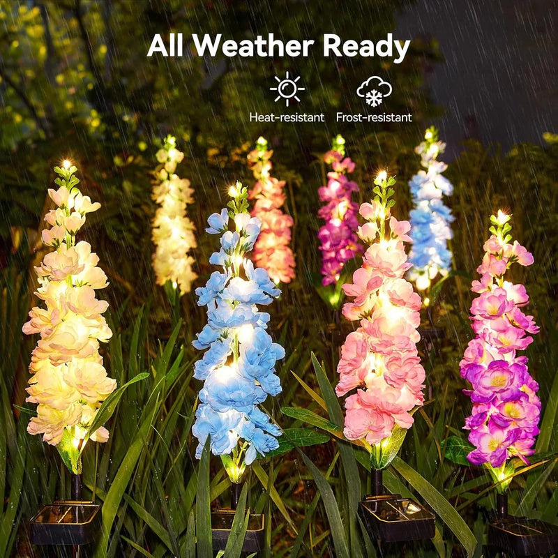 Solar delphinium flower light shown with its long stem and pointed ground stake for placement in soil and garden beds