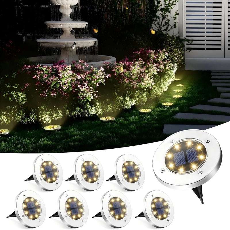 Round solar disk pathway lights used as subtle landscape accents around lawn edges, planting beds and outdoor walking areas