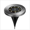 Round solar pathway disk light product view with a compact stainless steel housing and in-ground stake for outdoor use