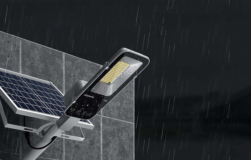 High-output solar flood light providing bright exterior illumination around a building and surrounding ground area at night
