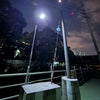 Dual-panel solar flood light photographed with its separate photovoltaic panels and high-output outdoor LED fixture
