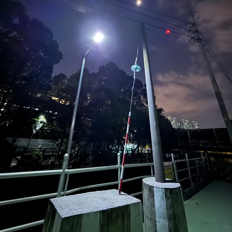 Dual-panel solar flood light photographed with its separate photovoltaic panels and high-output outdoor LED fixture