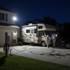 Solar flood light illuminating RV parking pad