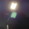Close product view of a commercial solar flood light showing its adjustable mounting bracket and weather-resistant construction