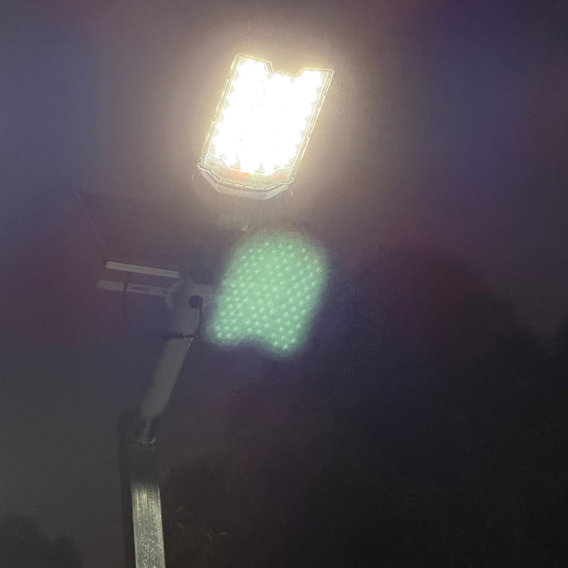 Close product view of a commercial solar flood light showing its adjustable mounting bracket and weather-resistant construction