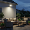 Solar lamp illuminating wooden deck with outdoor furniture