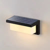 Side product view of an outdoor solar motion sensor light showing its compact wall-mounted housing and solar charging surface