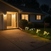 Solar mushroom and jellyfish stake lights decorating the entrance of a ranch-style home at dusk