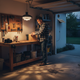 Split solar pendant light providing adjustable overhead illumination in a residential garage workshop