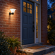 Solar radar wall light illuminating a red brick entryway and bluestone steps at dusk