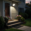 Solar sensor street lamp illuminating American home front entrance at dusk