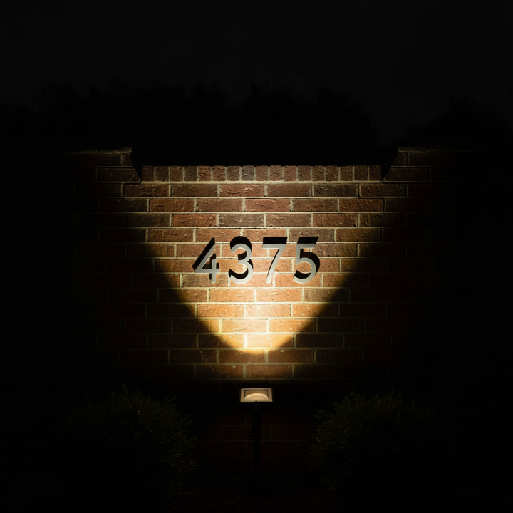 Solar spotlight as sole light source illuminating house numbers at night | NoxLumin
