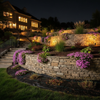 Solar spotlights illuminating terraced retaining wall landscaping at night
