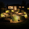Solar spotlights on rock garden with ornamental grasses at night