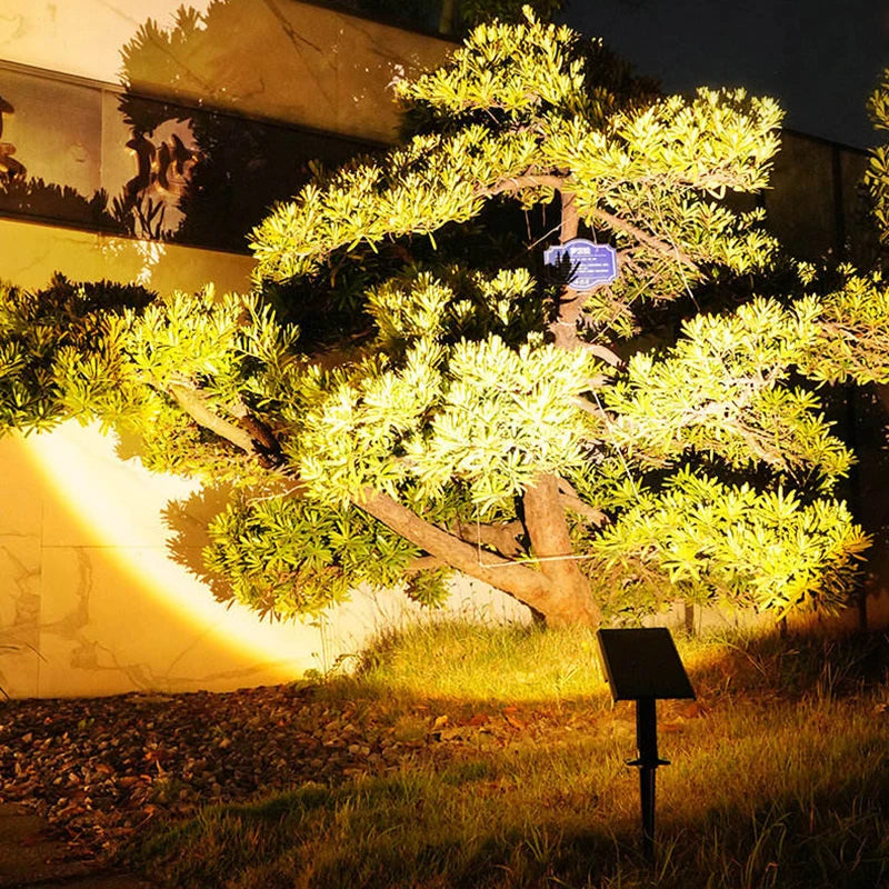 Solar tree light day-and-night graphic showing daytime charging and automatic landscape illumination after dark