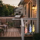 Solar delphinium flower lights decorating a suburban backyard deck at dusk